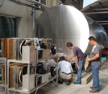 global-dairy-farm-service-team-working-on-tank